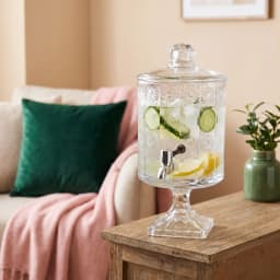 Clear glass beverage dispenser with decorative patterned body, silver spigot, and matching lid on a white background. - view 5