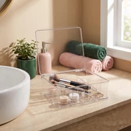 Clear acrylic storage box with a hinged lid and 12 compartments, filled with tea bags and coffee pods on a kitchen counter. - view 7