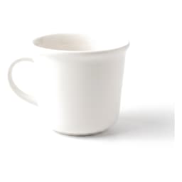 Single white ceramic mug with a handle on a white surface against a light brown wooden background - view 2
