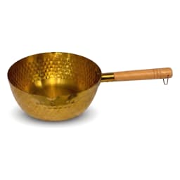 Golden hammered stainless steel pan with a light wooden handle, filled with small potatoes, rosemary, and garlic on a white… - view 2