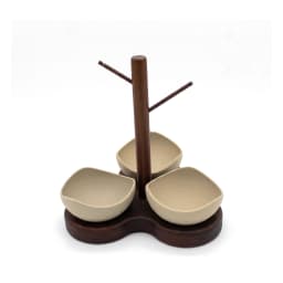 Dark brown wooden serving stand with three light beige porcelain bowls, wavy shape, on a white background. - view 2
