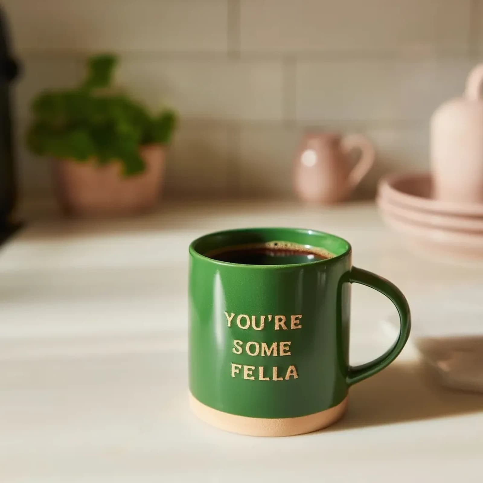 Bright green ceramic mug with a natural beige base and raised beige text 'YOU'RE SOME FELLA' on a white background