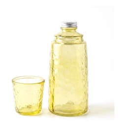Light green textured glass bottle with silver cap and matching small glass cup on a white shelf. - view 2