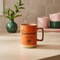 Single orange ceramic mug with a natural clay base and handle, featuring 'Simmer DEEPER' text and a heart in black. - view 1