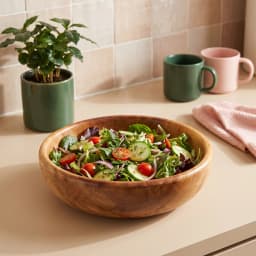Light brown wooden serving bowl with natural wood grain visible on a white background. - view 3