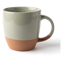 Single ceramic mug with a light green top and a terracotta bottom, on a white shelf. - view 2