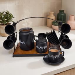 Complete 17-piece black ceramic coffee and tea set on a dark wooden tray with a black metal stand, white background. - view 1
